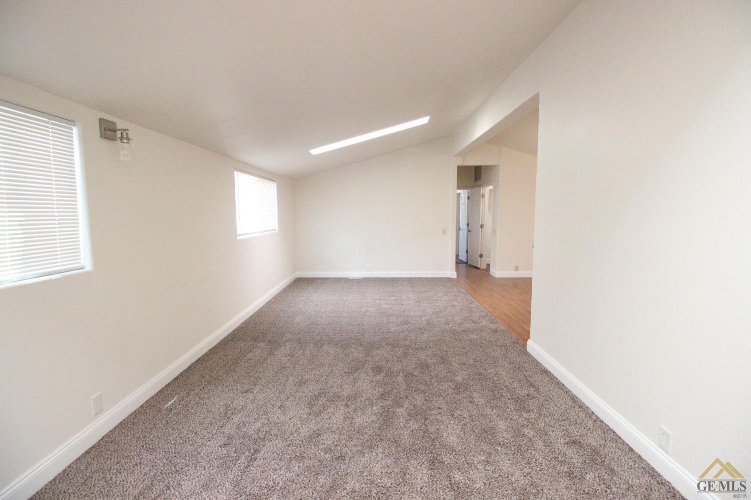 Undisclosed Address Bakersfield, CA 93308 - Photo 13 of 26 a view of a big room with windows and chandelier fan