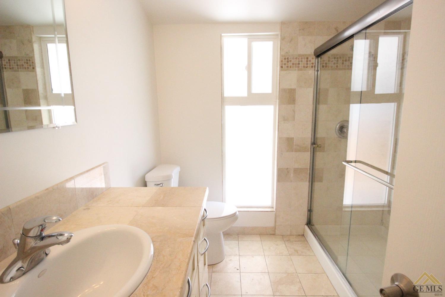 Undisclosed Address Bakersfield, CA 93308 - Photo 16 of 26 a bathroom with a sink and a mirror