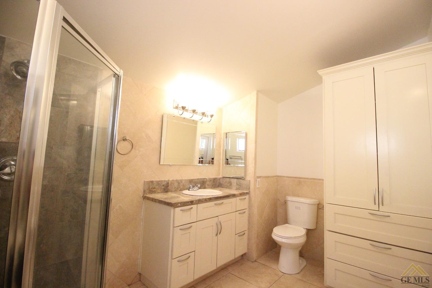 Undisclosed Address Bakersfield, CA 93308 - Photo 19 of 26 a bathroom with a granite countertop sink toilet and shower
