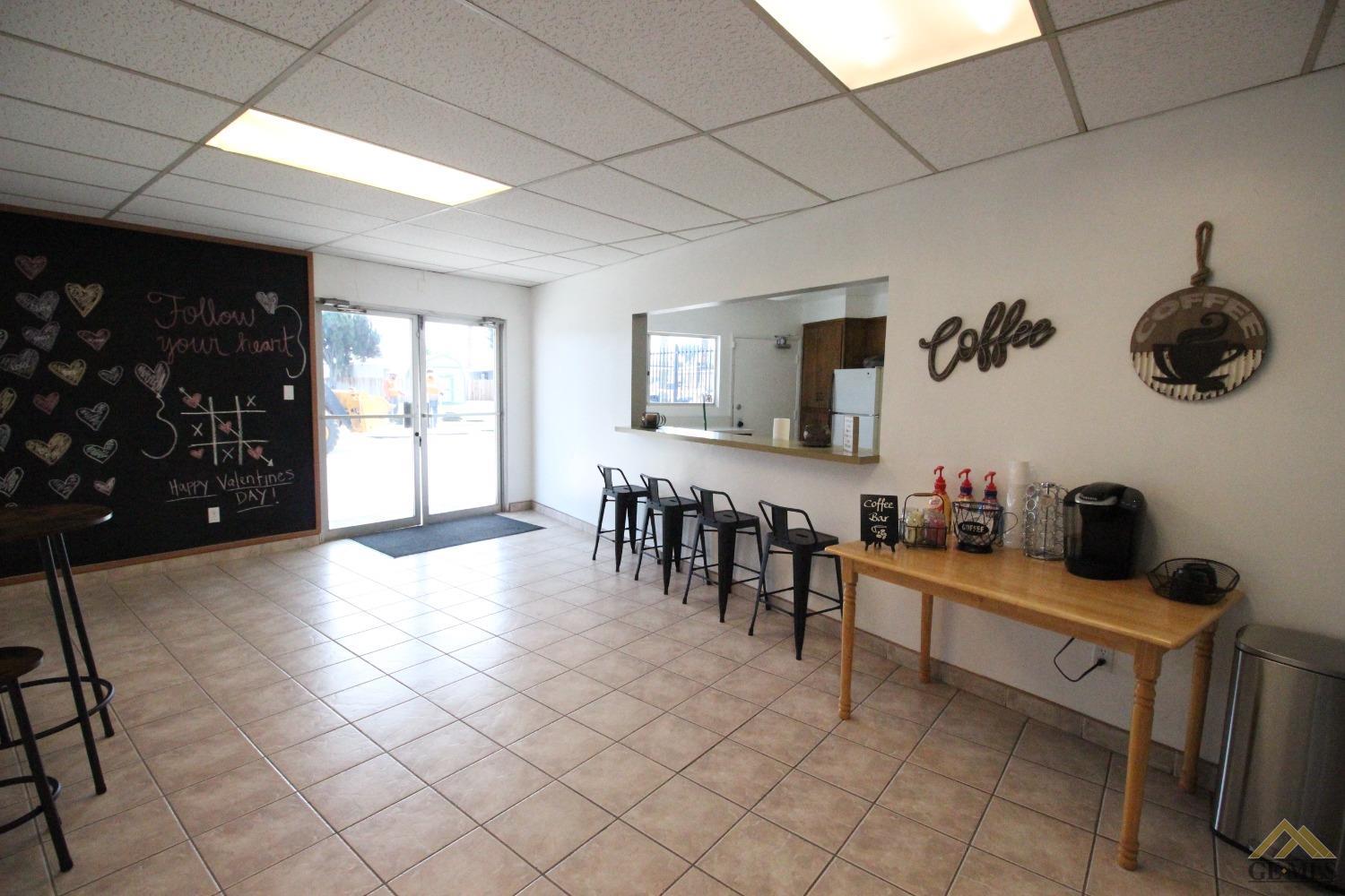 Undisclosed Address Bakersfield, CA 93308 - Photo 23 of 26 a kitchen with granite countertop a stove a sink and a microwave