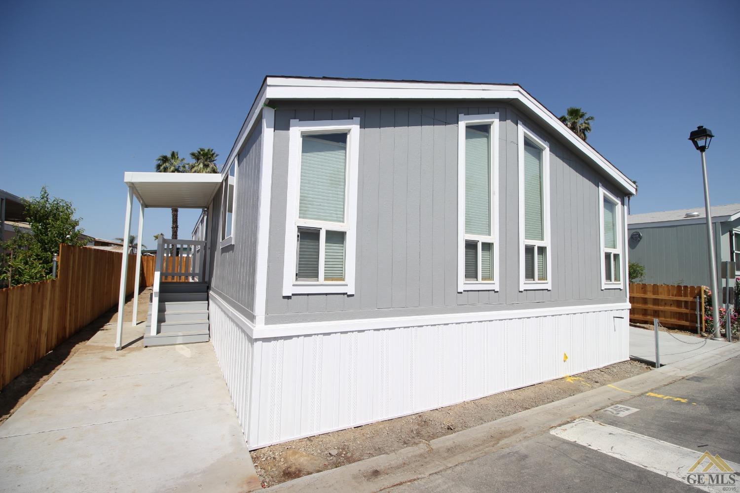 Undisclosed Address Bakersfield, CA 93308 - Photo 3 of 26 a front view of a house with a yard