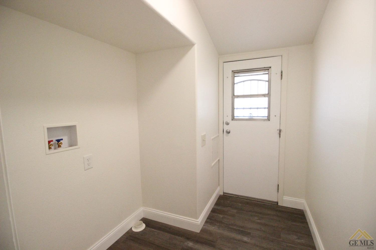 Undisclosed Address Bakersfield, CA 93308 - Photo 7 of 26 an empty room with wooden floor and windows