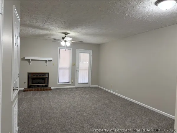 a kitchen with stainless steel appliances granite countertop a refrigerator a sink dishwasher and wooden cabinets with wooden floor