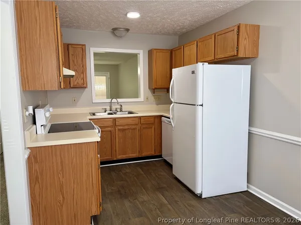 an empty room with a ceiling fan and windows