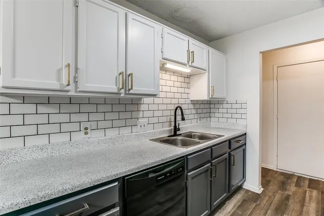 a kitchen with a sink and cabinets
