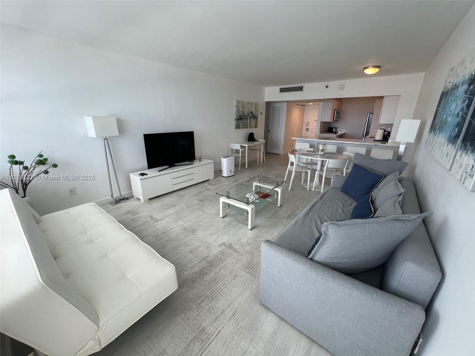 100 Lincoln Road, Unit 1244 Miami Beach, FL 33139 - Photo 13 of 68 a living room with furniture and a flat screen tv