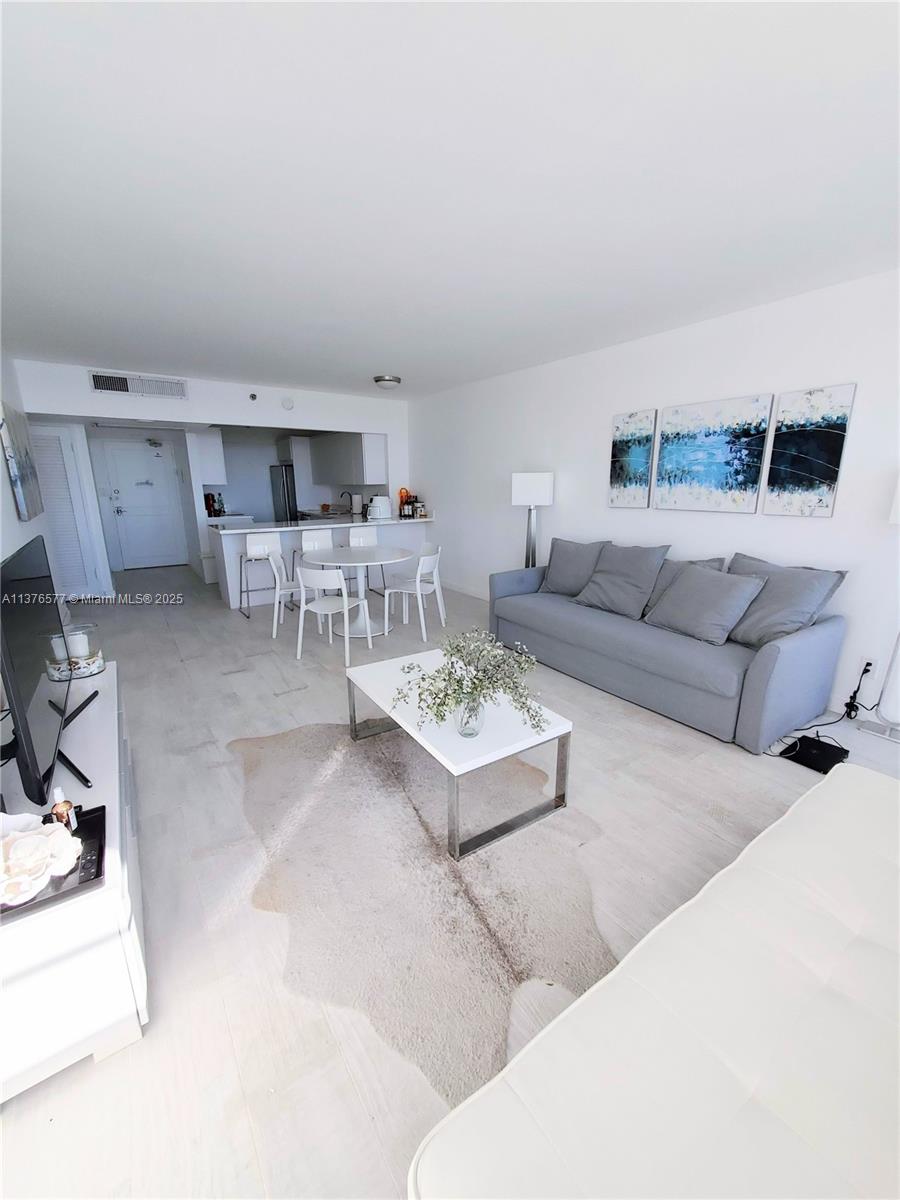 100 Lincoln Road, Unit 1244 Miami Beach, FL 33139 - Photo 15 of 68 a living room with furniture and a table