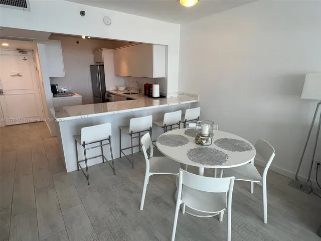 a kitchen with a refrigerator and a stove top oven