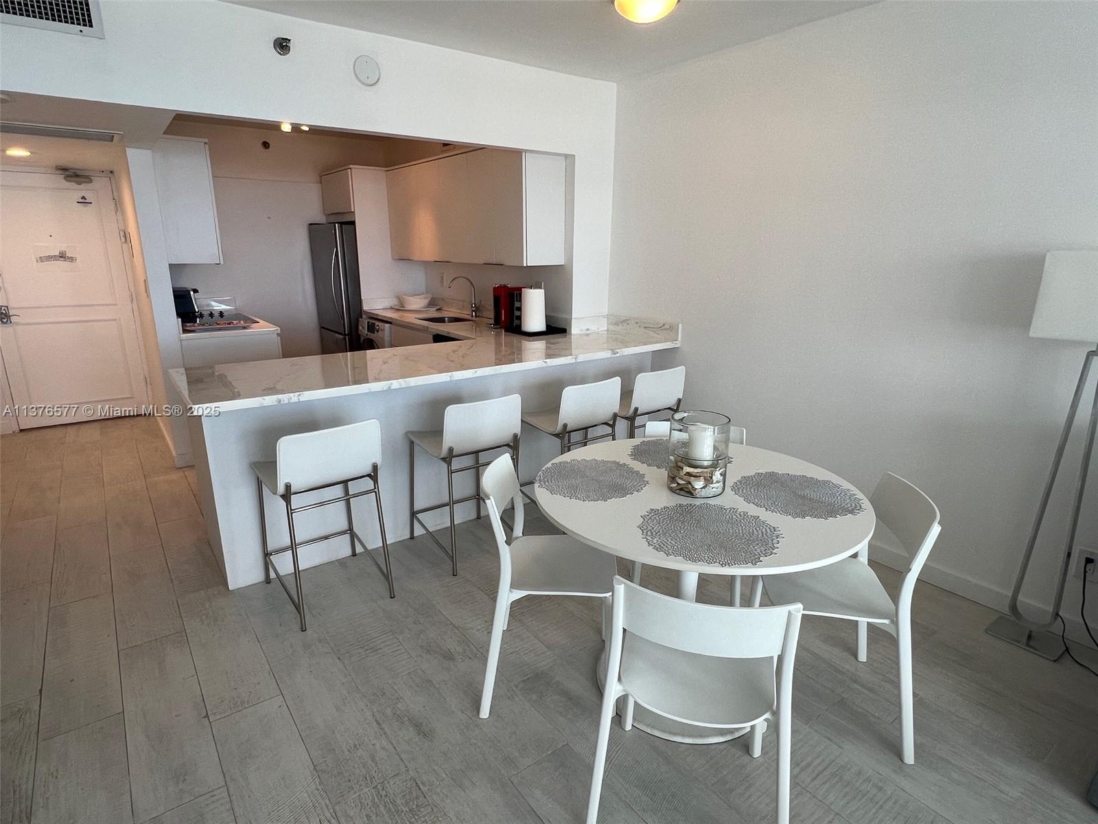 100 Lincoln Road, Unit 1244 Miami Beach, FL 33139 - Photo 17 of 68 a dining room with furniture and wooden floor