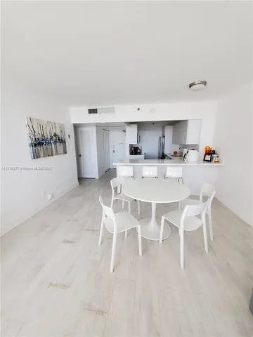 a spacious bedroom with a bed and a flat screen tv