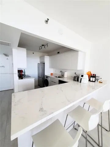 a bedroom with two beds and a couch