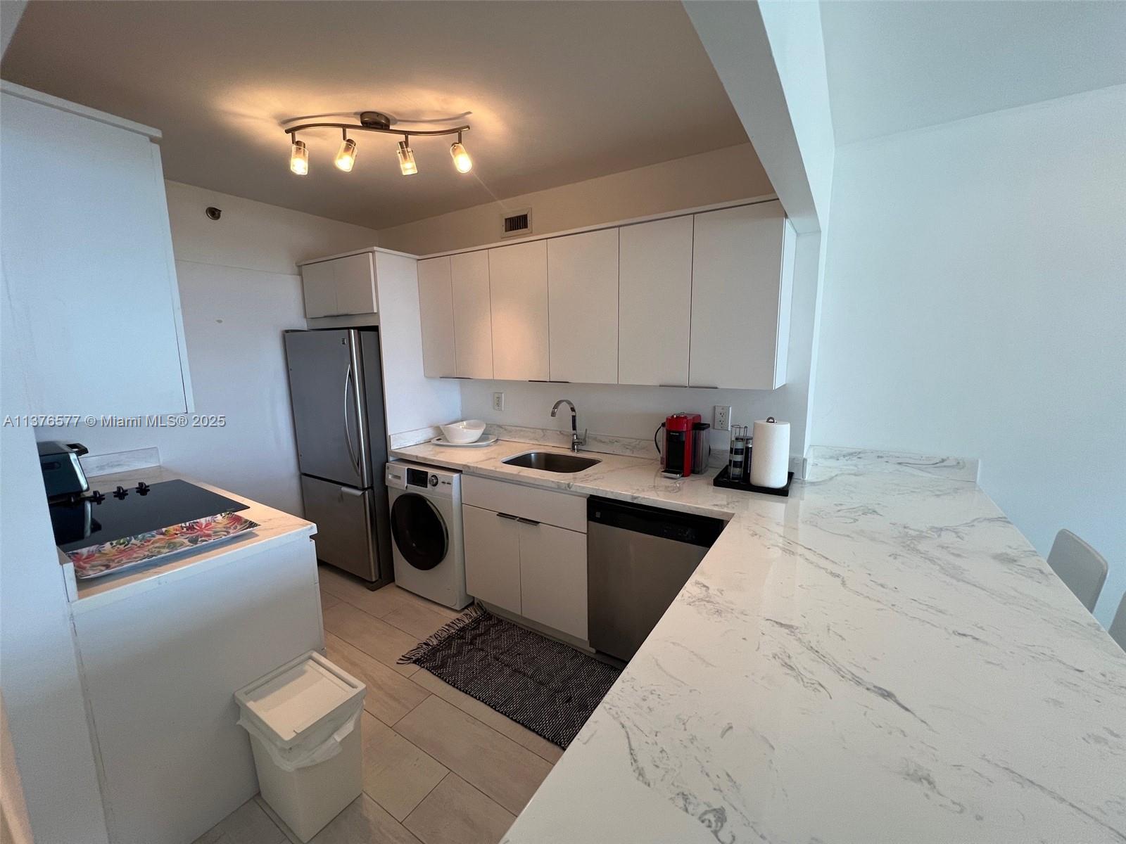 100 Lincoln Road, Unit 1244 Miami Beach, FL 33139 - Photo 20 of 68 a kitchen with a refrigerator and a stove top oven