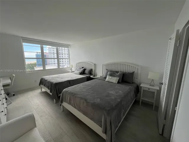 a bathroom with a sink a toilet a mirror and shower