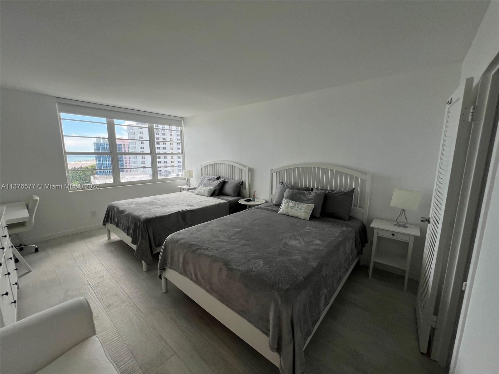 100 Lincoln Road, Unit 1244 Miami Beach, FL 33139 - Photo 22 of 68 a bedroom with two beds and a couch