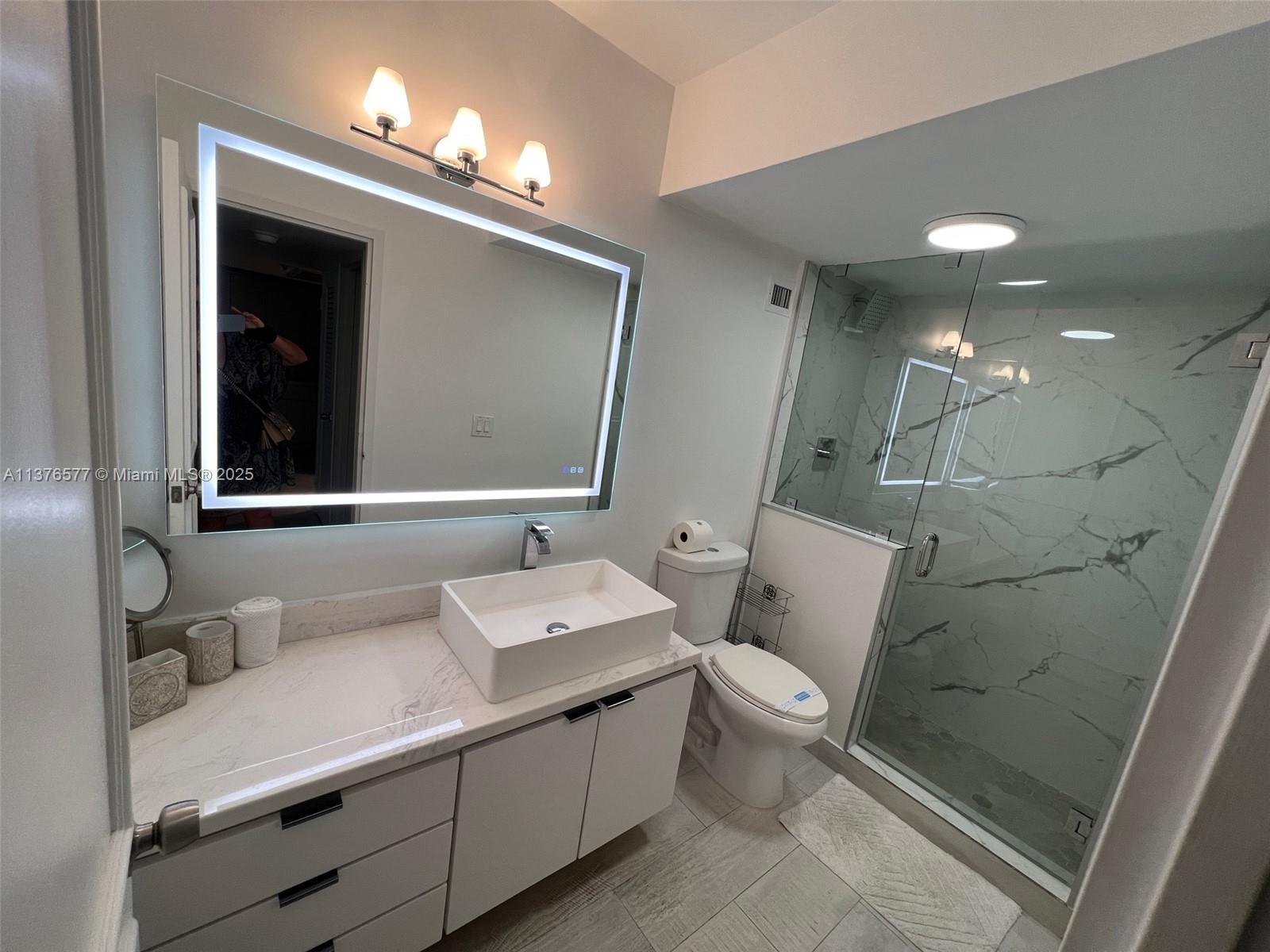 100 Lincoln Road, Unit 1244 Miami Beach, FL 33139 - Photo 26 of 68 a bathroom with a double vanity sink mirror and toilet
