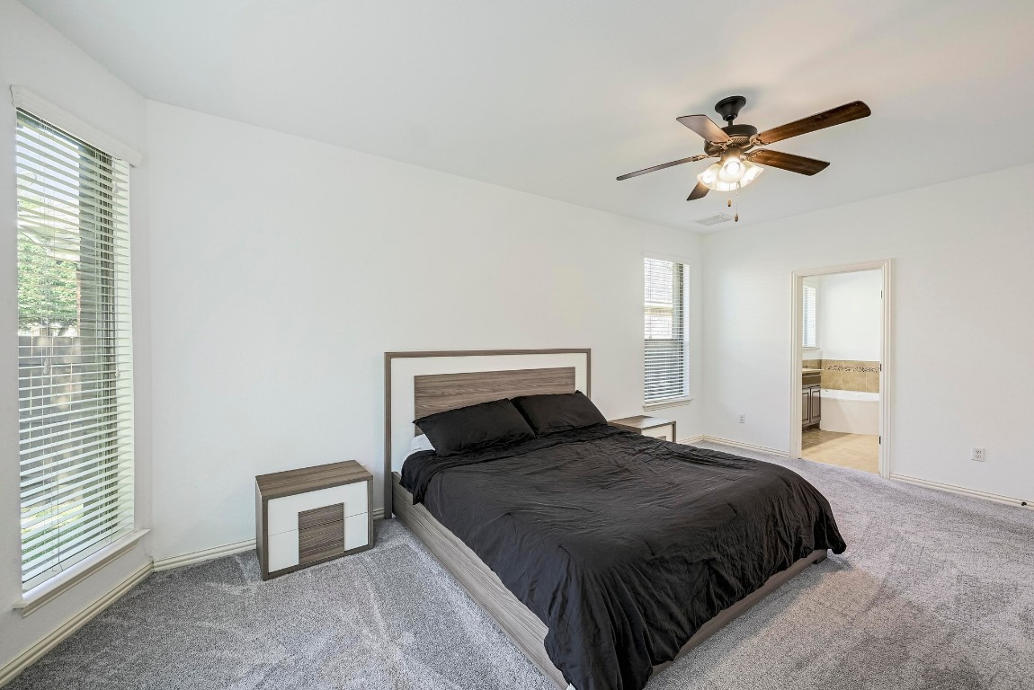 2229 Turtle Mountain Bend Austin, TX 78748 - Photo 16 of 38 a bedroom with a large bed and a ceiling fan