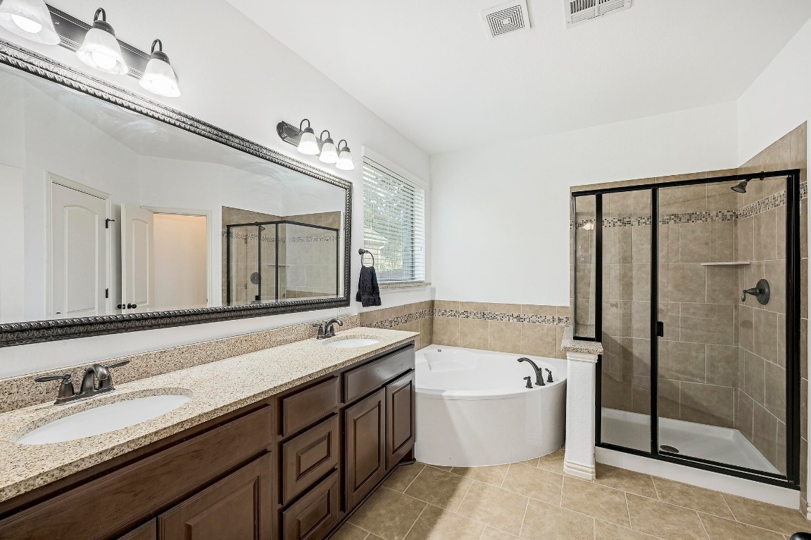 2229 Turtle Mountain Bend Austin, TX 78748 - Photo 17 of 38 a bathroom with a granite countertop bathtub sink double and mirror