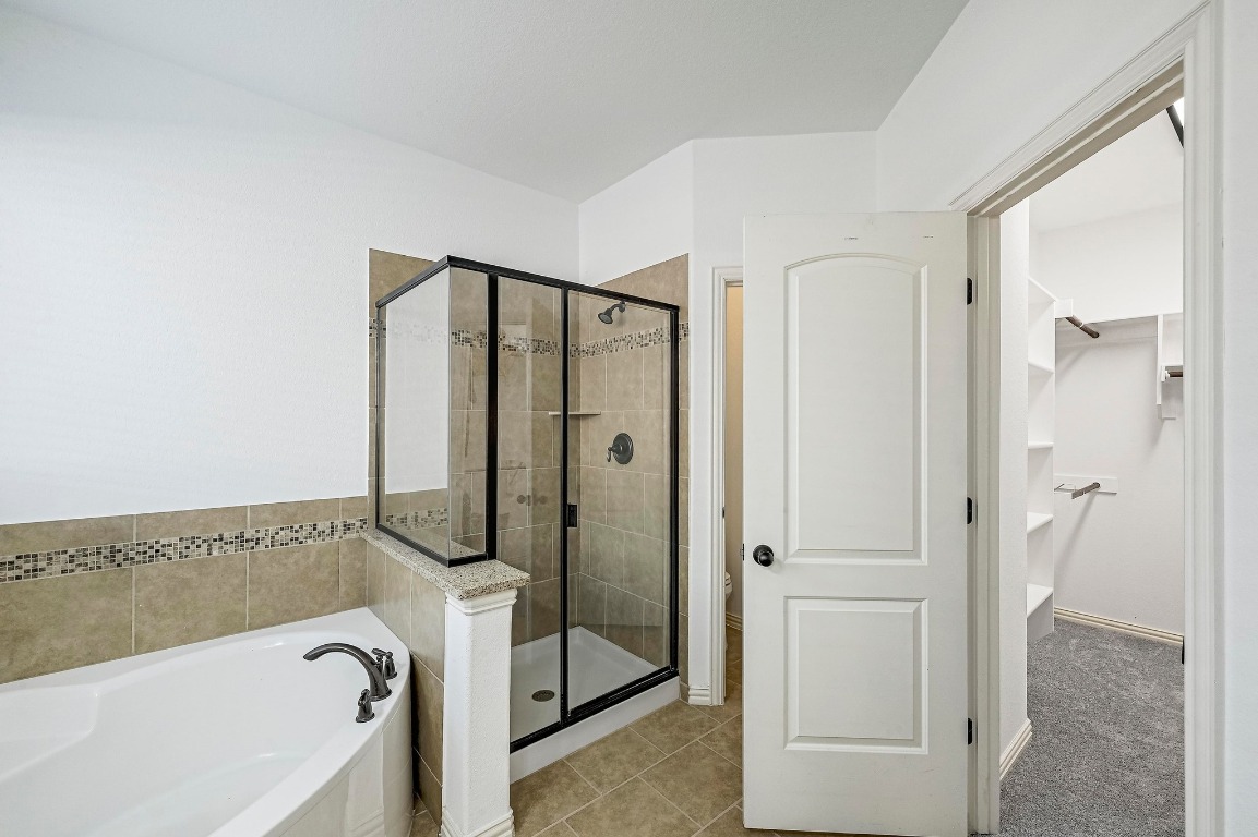 2229 Turtle Mountain Bend Austin, TX 78748 - Photo 18 of 38 a bathroom with a tub and a shower
