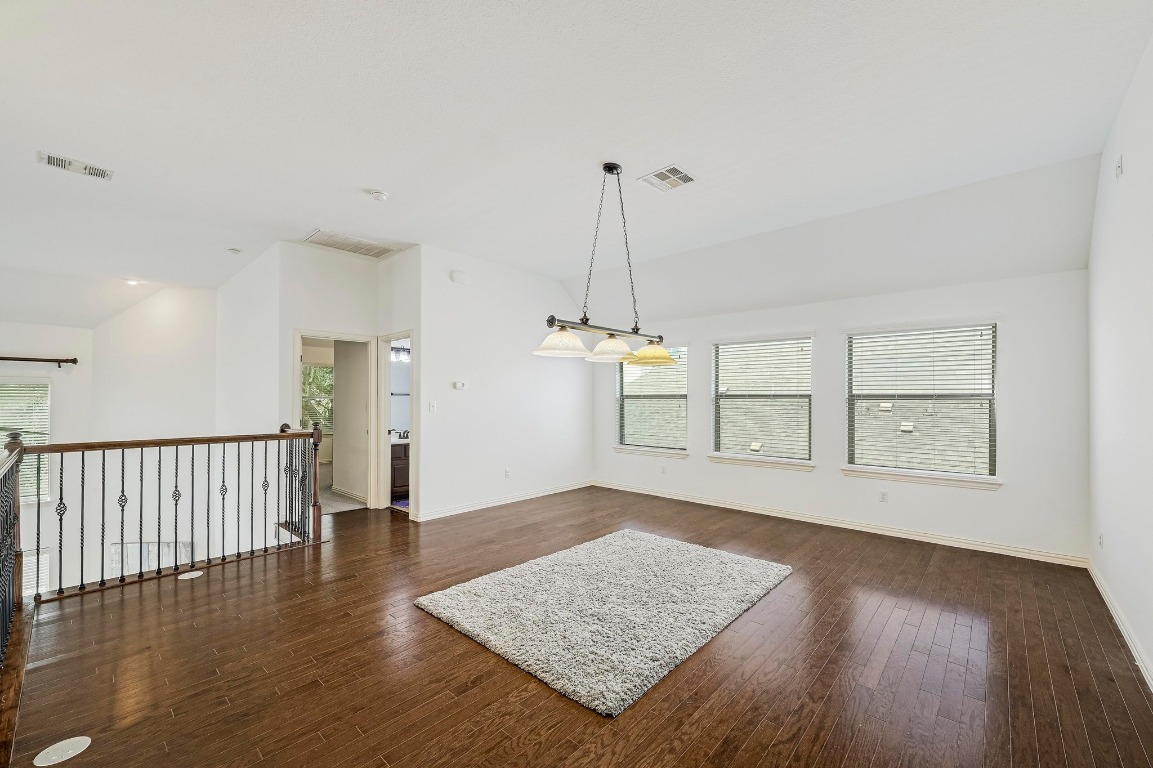 2229 Turtle Mountain Bend Austin, TX 78748 - Photo 23 of 38 a view of an empty room with wooden floor and a window