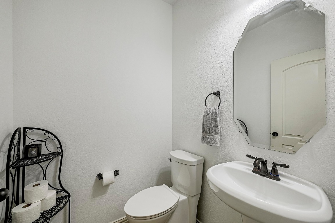2229 Turtle Mountain Bend Austin, TX 78748 - Photo 32 of 38 a bathroom with a toilet sink and mirror