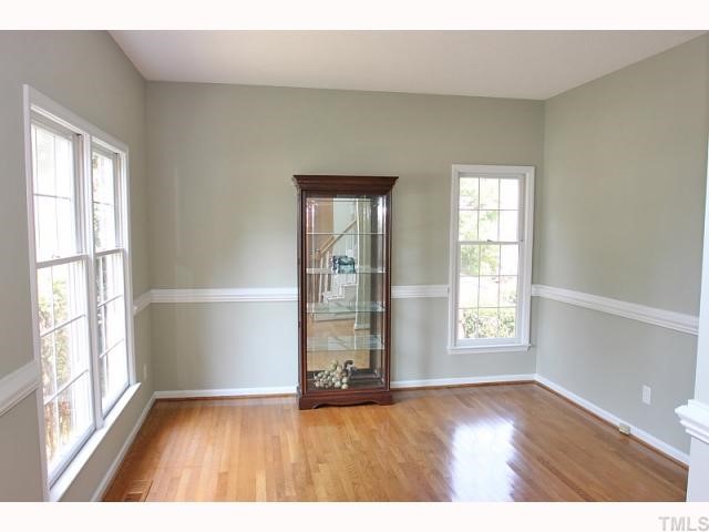112 Fetzer Court Cary, NC 27513 - Photo 4 of 12 an empty room with wooden floor and windows
