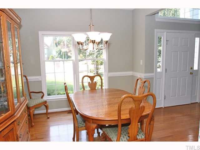 112 Fetzer Court Cary, NC 27513 - Photo 5 of 12 a dining room with furniture a chandelier and wooden floor