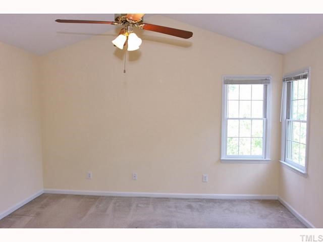 112 Fetzer Court Cary, NC 27513 - Photo 8 of 12 an empty room with windows and fan
