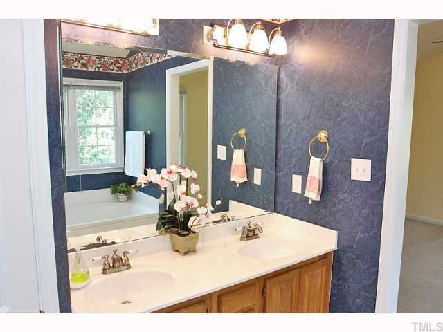 112 Fetzer Court Cary, NC 27513 - Photo 9 of 12 a bathroom with a sink a vanity and a mirror