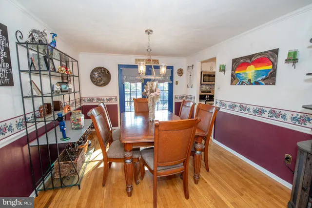 a dining room with furniture and wooden floor