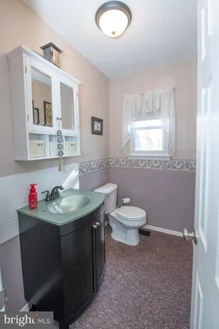 a bathroom with a sink toilet and mirror