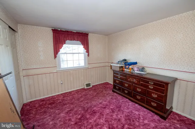 a bed room with a bed and a window