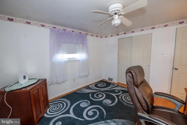 a view of a room with window and hardwood