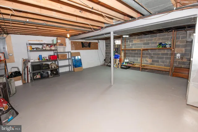 a view of a garage with storage and a white door