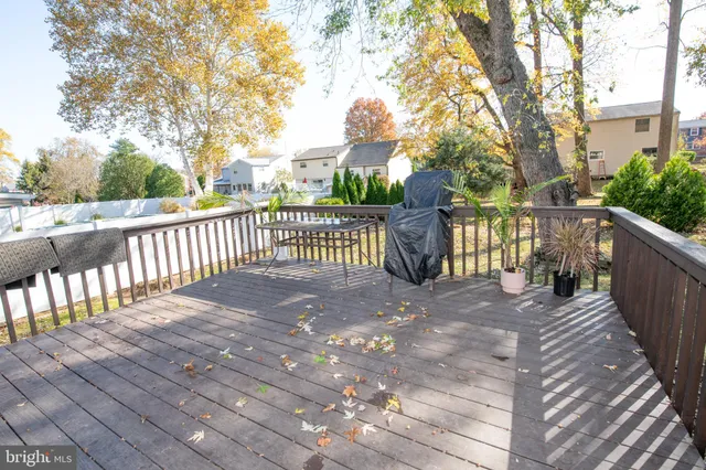a view of street with wooden deck and trees