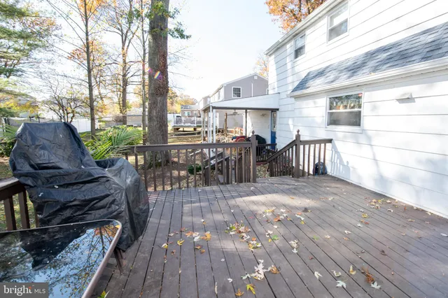 a view of a patio with table and chairs and wooden floor