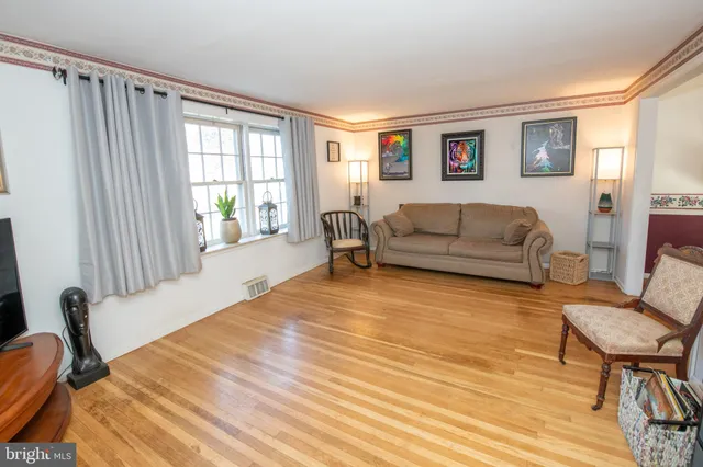 a bedroom with furniture and a wooden floor