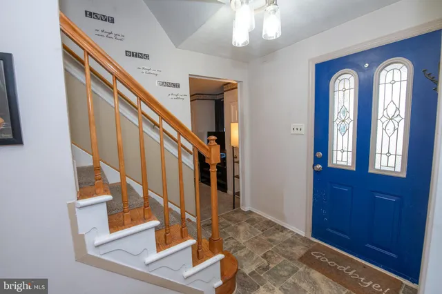 a view of an entryway with wooden floor and stairs