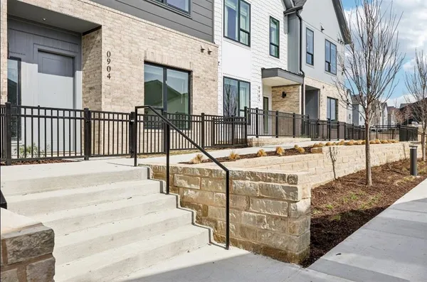 a view of a brick building next to a yard