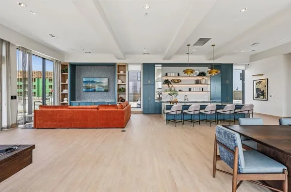 a living room with furniture a rug and painting on the wall