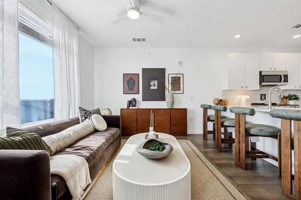 a living room with furniture and a large window