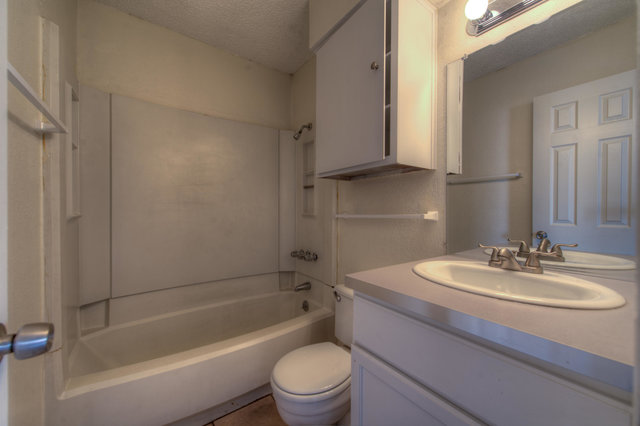 6906 Deep Circle, Unit B Austin, TX 78744 - Photo 17 of 19 Bathroom featuring vanity, shower / bath combination, and a textured ceiling