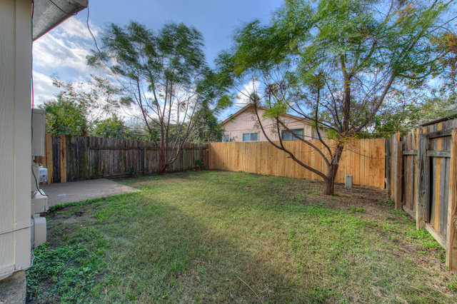 6906 Deep Circle, Unit B Austin, TX 78744 - Photo 2 of 19 Fenced backyard with a patio area