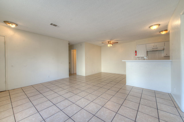 6906 Deep Circle, Unit B Austin, TX 78744 - Photo 8 of 19 Spare room featuring ceiling fan, a textured ceiling, and light tile patterned flooring