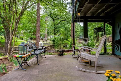 swimming pool with outdoor seating and trees