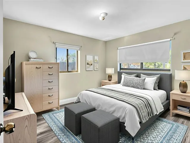 a bedroom with a large bed and a window