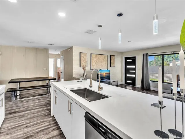 a kitchen with a sink and white cabinets