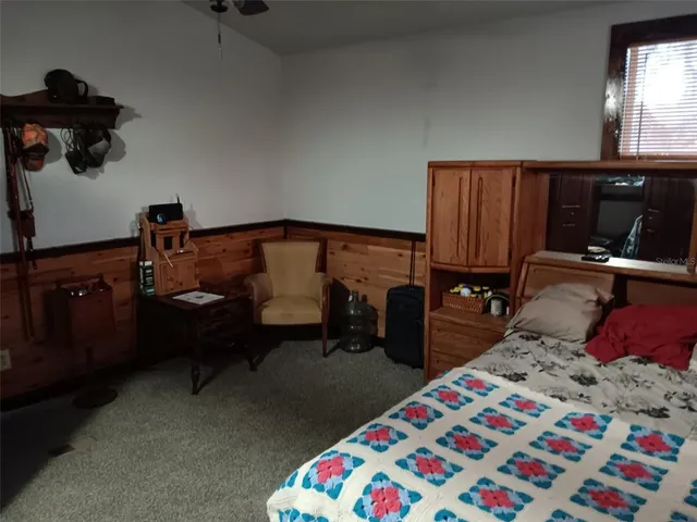 a bedroom with a bed and a dresser in it