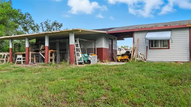 a view of a chairs and table in front of a house