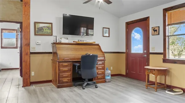 a view of a livingroom with furniture and a flat screen tv