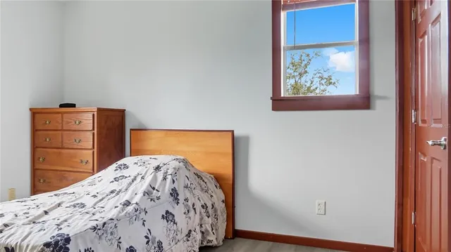 a bedroom with a bed and a dresser